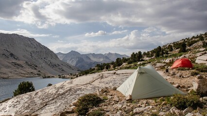 Tent on John Muir Trail, California against the cloudy sky in summer