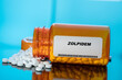 Leinwandbild Motiv Zolpidem white medical pills and tablets spilling out of a drug bottle. Macro top down view with copy space.