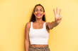 © kues1 - hispanic pretty woman smiling and looking friendly, showing number three or third with hand forward, counting down