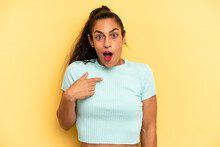 Hispanic Pretty Woman Looking Shocked And Surprised With Mouth Wide Open, Pointing To Self