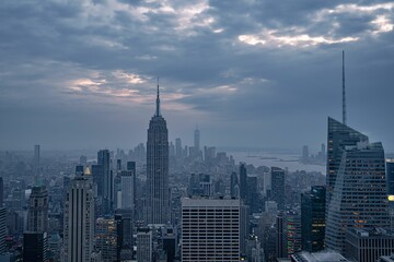 Sticker - Aerial view of the Empire State Building and modern skyscrapers in New York against a cloudy sky