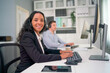© narong - Portrait of hispanic business woman look at camera during work as operator or customer support team and they stay in office.