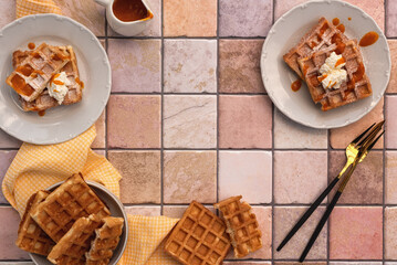 Wall Mural - Viennese waffles with cottage cheese and fruit sauce and decorated with powdered sugar. Photo of Viennese waffles on the kitchen table. The concept of a sweet breakfast. Top view. Copy space.