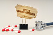© Dzmitry - Near the stethoscope are pills and a clip with a cardboard sign - health misinformation
