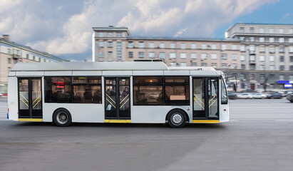 Poster - Bus moves along the street in the city.