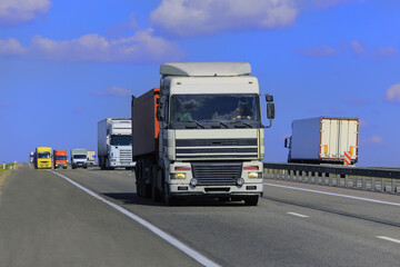 Sticker - Trucks move along a suburban highway