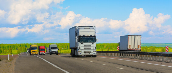 Wall Mural - Trucks move along a suburban highway