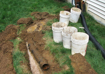 Sewerage system problem. Black corrugated plastic pipe on ground. Pipes for use in outdoor. 