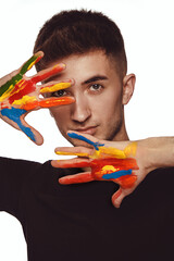 Wall Mural - Young man with colorful paint on his hands