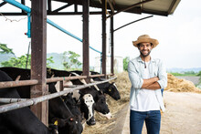 Portrait Of Caucasian Male Dairy Farmer Working Outdoors In Cow Farm.