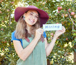 © Jade M/peopleimages.com - Female apple farmer hiring workers to help on her fruit farm during harvest. Portrait of happy young woman advertising jobs and finding recruitment in an orchard on a sunny day near trees.
