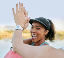 Two Friends Sharing High Five And Celebrating Their Success While Being Active Outdoors. Cheerful Woman Out Kayaking And Motivating Her Partner While Enjoying A Water Activity On A Lake In Summer