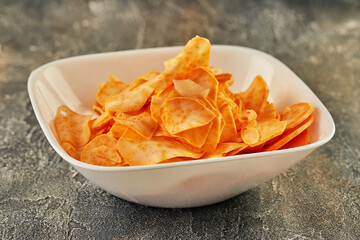 Wall Mural - Sweet potato chips in white plate are ready to be eaten