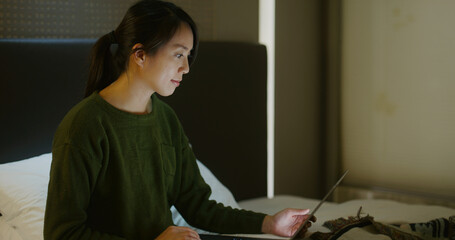 Wall Mural - Woman work on laptop computer on bed at night