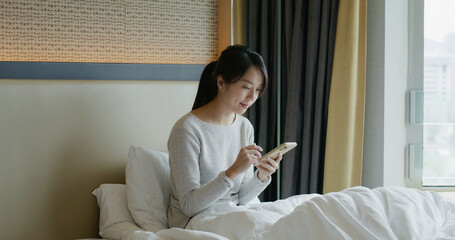 Canvas Print - Woman work on cellphone on bed