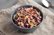 Homemade Coleslaw with Cabbage and Carrots in a Bowl, side view.