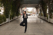 © Manuel - Young man with beard and ponytail, wearing black shirt with white polka dots and black pants and jacket, dancing flamenco in the middle of the city. Concept art, dance, culture, tradition.