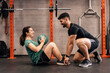 © JavierBallesterLegua - Personal trainer with a first-time trainee correcting habits in the exercise room. Personalized individual training