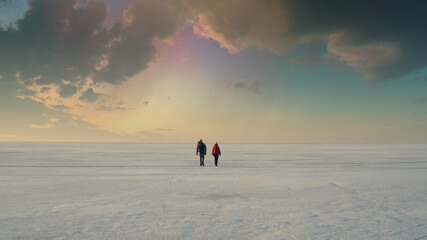 the two travelers going on the snowy landscape background