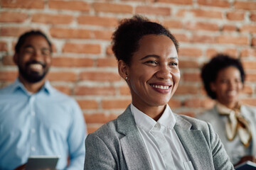 Wall Mural - Happy African American female leader and her business team in office.