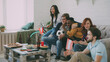 © silverkblack - Happy friends with Austrian flags watching sports championship on TV together at home indoors and happy about winning of favourite team