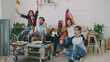 © silverkblack - Happy friends with German flags watching sports championship on TV together at home indoors and happy about winning of favourite team