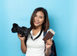 © suriya - Traveler tourist Asian women holding passport with camera isolated on blue background , Travel Holiday Concept