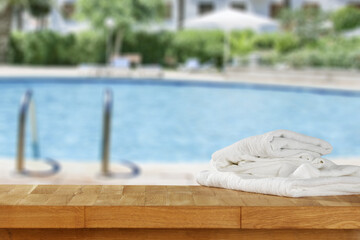 Sticker - Desk with towels and swimming pool  background. 