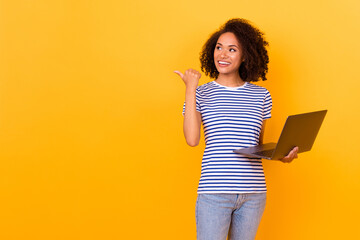 Poster - Portrait of positive nice lady look indicate thumb finger empty space isolated on yellow color background