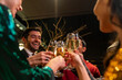 © CandyRetriever  - Group of Diversity people celebrating and toasting champagne glass together at luxury restaurant bar. Happy man and woman friends enjoy and fun holiday hangout party meeting nightlife at nightclub