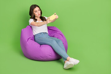 Poster - Photo of dreamy lovely woman dressed white t-shirt sitting bean bag tacking selfie gadget empty space isolated green color background