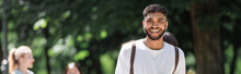 Cheerful African American Student Looking At Camera In Summer Park, Banner.