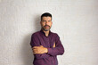 © Vergani Fotografia - Portrait of middle aged man arms crossed and looking at camera with serious face. Isolated on white brick wall