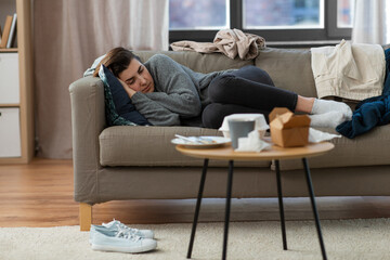 Wall Mural - mental health, psychological problem and depression concept - stressed woman lying on sofa at home