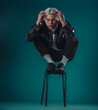 © qunica.com - Male beauty concept. Portrait of fashionable young man with stylish haircut wearing trendy glasses and sweater, posing over gray background. Perfect hair & skin. Hipster style. Copy-space. Studio shot
