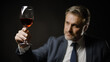 Bearded businessman in elegant suit drinking wine, enjoying flavor, degustation