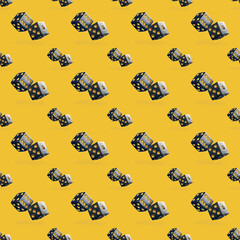 Seamless pattern of dice big and small on yellow background.