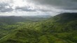 Aerial view of the green mountainous landscape on a cloudy day in the Philippines