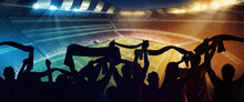 Back View Of Football, Soccer Fans Cheering Their Team With Scarfs At Crowded Stadium At Evening Time. Concept Of Sport, Support, Competition. Out Of Focus Effect