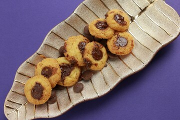 Wall Mural - Cookies with chocolate filling are placed in a decorative plate in the form of a leaf.