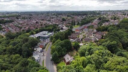 Canvas Print - Aerial view looking down onto buildings and roads with views towards Manchester City centre in the background. Taken in Bury Lancashire England. 