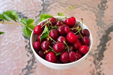 Canvas Print - Delicious red cherries, summer fruits, in a basket, on a wooden table