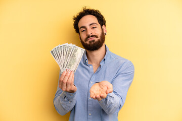 young man smiling happily with friendly and  offering and showing a concept. dollar banknotes concept