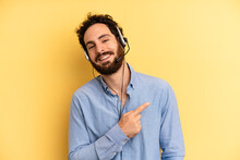 Young Man Smiling Cheerfully, Feeling Happy And Pointing To The Side. Telemarketer Concept