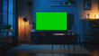 © Gorodenkoff - Stylish Loft Apartment Interior with TV Set with Green Screen Mock Up Display Standing on Television Stand. Empty Living Room at Home with Chroma Key Placeholder on Monitor. Night Shot.