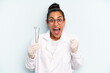 © kues1 - hispanic woman feeling shocked,laughing and celebrating success. dentist concept