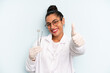 © kues1 - hispanic woman feeling proud,smiling positively with thumbs up. dentist concept