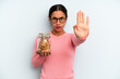 © kues1 - hispanic woman looking serious showing open palm making stop gesture. home made cookies concept