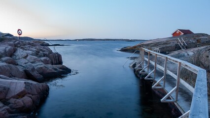 Sticker - Beautiful view of the wooden pier and rocks near the lake in Sweden