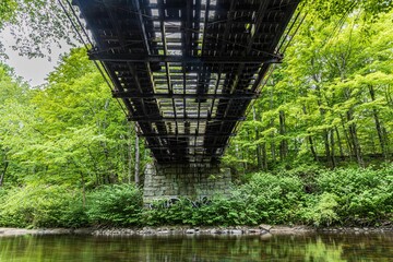 Wall Mural - Low angle shot of a beautiful bridge constructed above the water in Lancaster, MA, USA